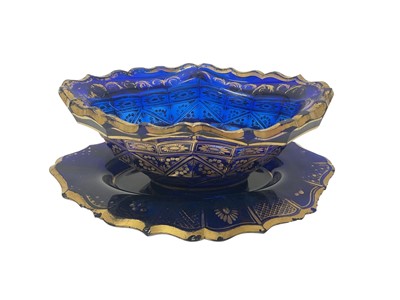 Lot 329 - 18th century Bristol blue glass lozenge shape bowl and stand, with rich floral gilding possibly done in the workshop of James Giles, the stand 21.5cm across