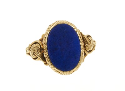 Lot 696 - 19th century style gold and lapis lazuli signet ring, the oval lapis lazuli panel to the bezel in a gold mount with pierced floral shoulders on beaded gold shank, stamped 585, ring size approxim...