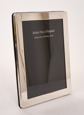 Lot 447 - Elizabeth II silver photograph frame of plain rectangular form, with easel support, (London 1999), maker Arthur Price & Co., with original box, frame 21.5 x 16.5cm, image size 17.9 x 12.6cm ...