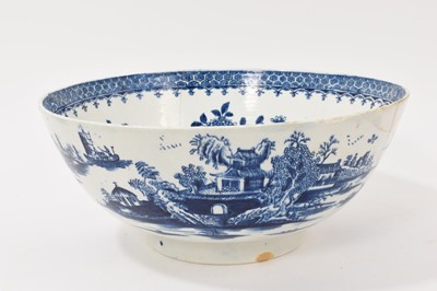 Lot 5038 - Lowestoft blue and white punch bowl, circa 1775, printed to the exterior with figures in a Chinese island landscape, with further similar landscape vignettes, the interior with floral sprays and...