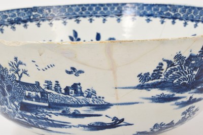 Lot 5038 - Lowestoft blue and white punch bowl, circa 1775, printed to the exterior with figures in a Chinese island landscape, with further similar landscape vignettes, the interior with floral sprays and...