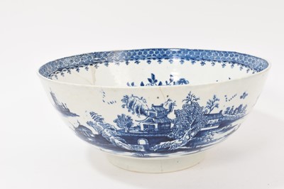 Lot 5038 - Lowestoft blue and white punch bowl, circa 1775, printed to the exterior with figures in a Chinese island landscape, with further similar landscape vignettes, the interior with floral sprays and...