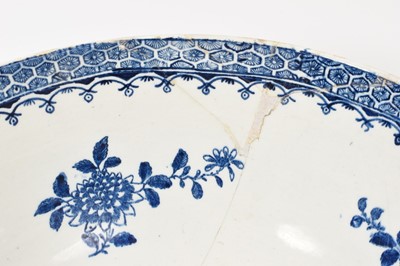 Lot 5038 - Lowestoft blue and white punch bowl, circa 1775, printed to the exterior with figures in a Chinese island landscape, with further similar landscape vignettes, the interior with floral sprays and...