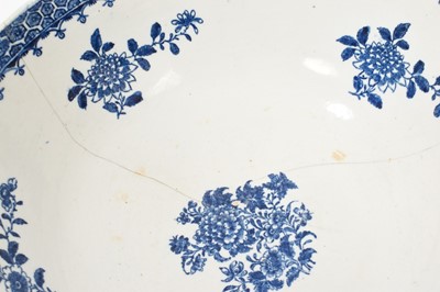 Lot 5038 - Lowestoft blue and white punch bowl, circa 1775, printed to the exterior with figures in a Chinese island landscape, with further similar landscape vignettes, the interior with floral sprays and...
