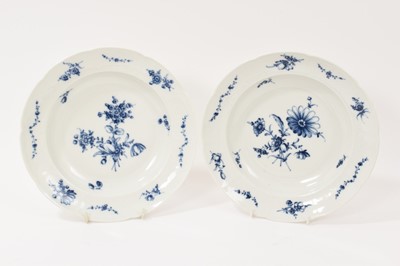 Lot 5037 - Two 18th century Furstenberg porcelain shallow plates, painted with floral sprays and swags, the edge moulded with scrollwork cartouches, underglaze blue 'F' mark to bases, 23.75c diameter