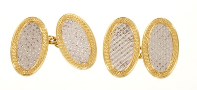 Lot 697 - Pair of 1920s 18ct gold and platinum cufflinks with engine turned oval panels