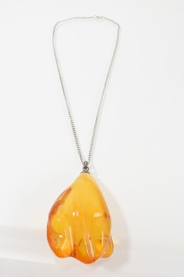 Lot 270 - Large amber pendant (possibly reformed) on a plated chain