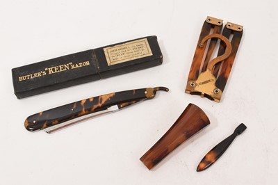 Lot 1027 - Collection of tortoiseshell works of art including an early 20th century folding coat hanger, razor and two handles