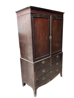 Lot 1313 - George III mahogany linen press, the upper section now with hanging rail, enclosed by a pair of panel doors, the lower part with two short over two long drawers on bracket feet, 121cm wide x 60c...