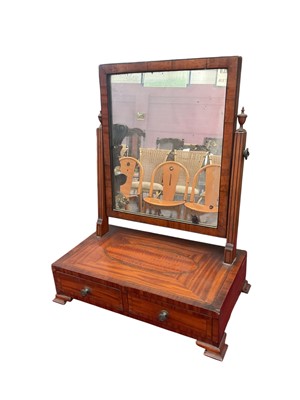 Lot 1492 - Regency satinwood toilet mirror, with rectangular swing plate and two drawers to the platform base, on bracket feet, 43cm wide