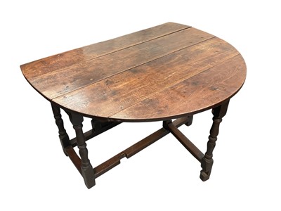 Lot 1497 - Early 18th century oak gateleg dining table, the oval hinged top on end drawer and turned and block understructure, 120 x 140cm