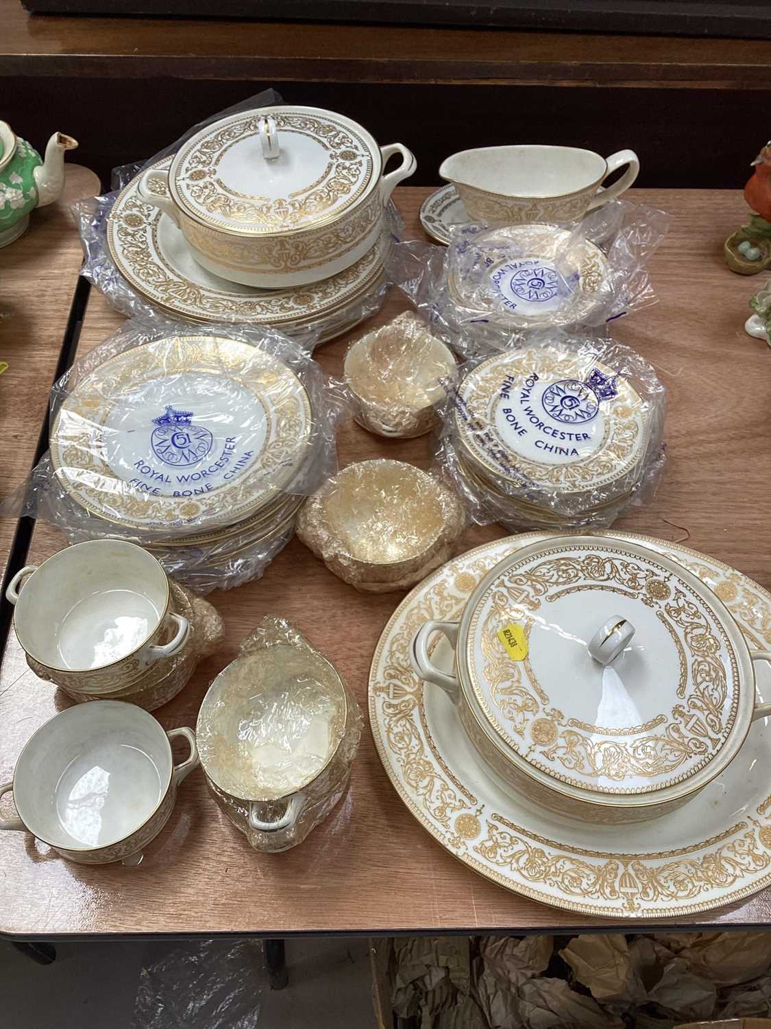 Lot 5097 - Royal Worcester gilt Hyde Park pattern part dinner service, comprising two tureens, gravy boat, soup cups, plates of various size