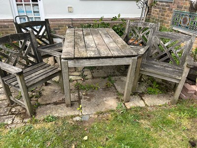 Lot 1511 - Suite of teak garden furniture comprising table and set of four lattice back elbow chairs