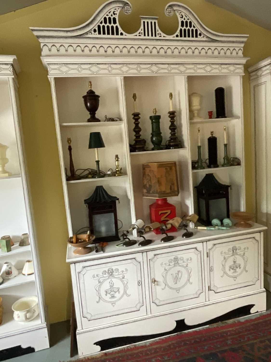Lot 5369 - Highly decorative handmade and painted two height bookcase, with arched pediments and cupboards below, 180cm wide x 54cm deep x 295cm high