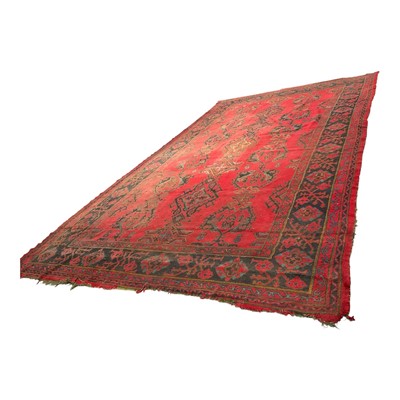 Lot 1513 - Very large antique Turkish ushak carpet, with repeat medallions on brick red ground