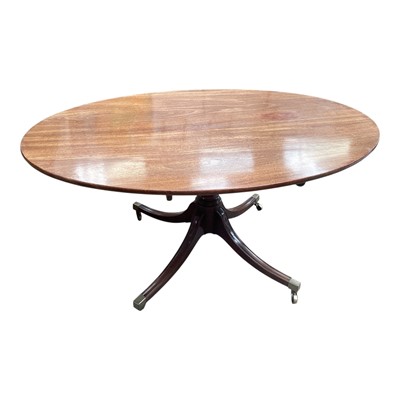 Lot 1519 - Regency mahogany oval breakfast table, on base shaped column and spread quadruped supports terminating in brass cappings and castors, 155cm wide x 55cm deep x 102cm high, together with a well up...