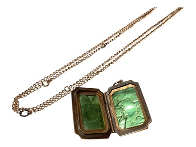 Lot 4 - 9ct gold back and front rectangular locket and a yellow metal chain (2)