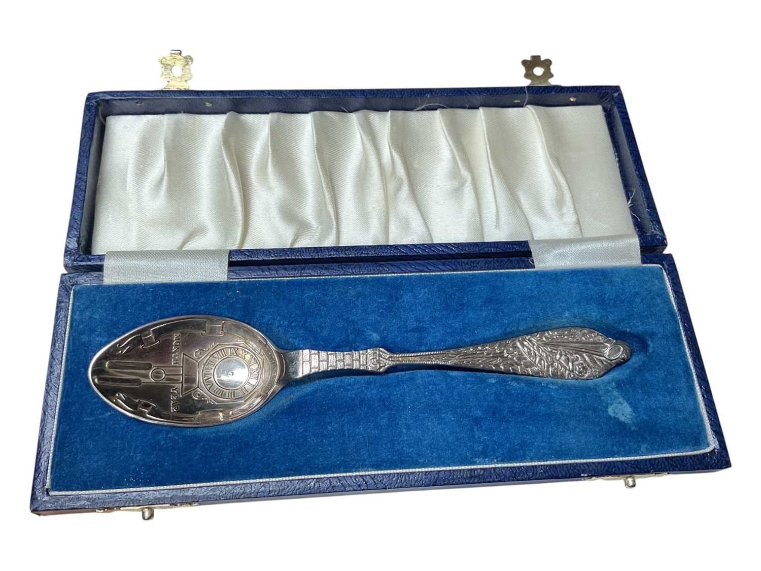 Lot 11 - Silver christening spoon with clock decoration to the bowl and a stork carrying a baby to the handle (Birmingham 1990), in fitted case