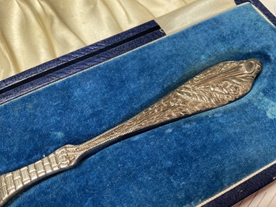 Lot 11 - Silver christening spoon with clock decoration to the bowl and a stork carrying a baby to the handle (Birmingham 1990), in fitted case