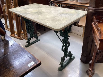 Lot 5358 - Victorian cast iron garden table with simulated marble top on pierced end standards, 121cm wide x 56cm deep x 80cm tall