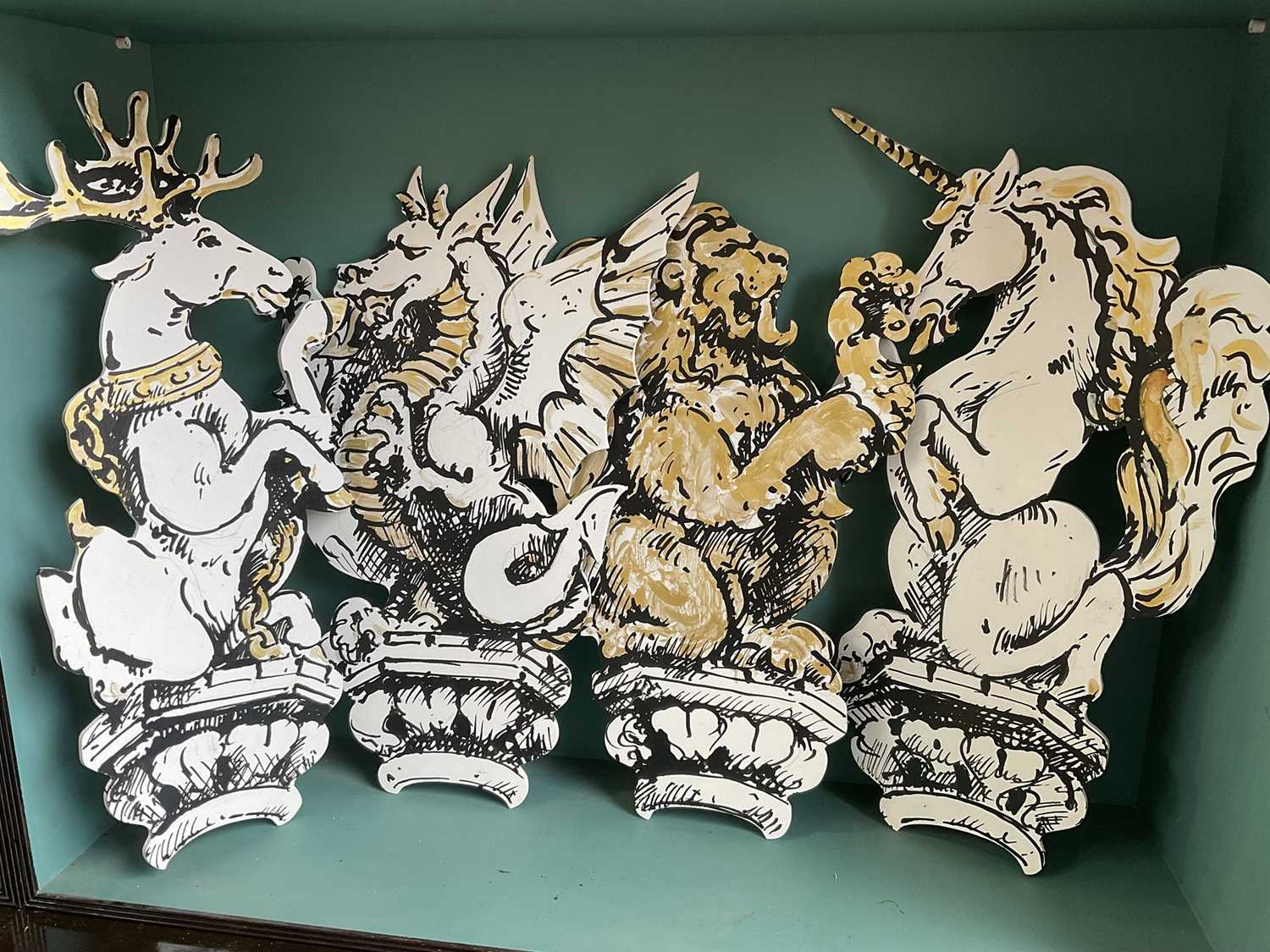 Lot 5169 - Set of four stylish hand painted dummy boards, in the form of busts of heraldic beasts