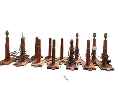 Lot 5203 - Collection of 13 fruitwood and satinwood cross handed Art Deco style table lamps, 'Manhattan' pattern, 36cm high
