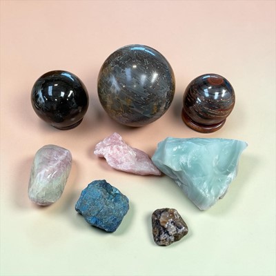 Lot 5238 - Three polished mineral spheres on wooden stands, together with three other mineral samples