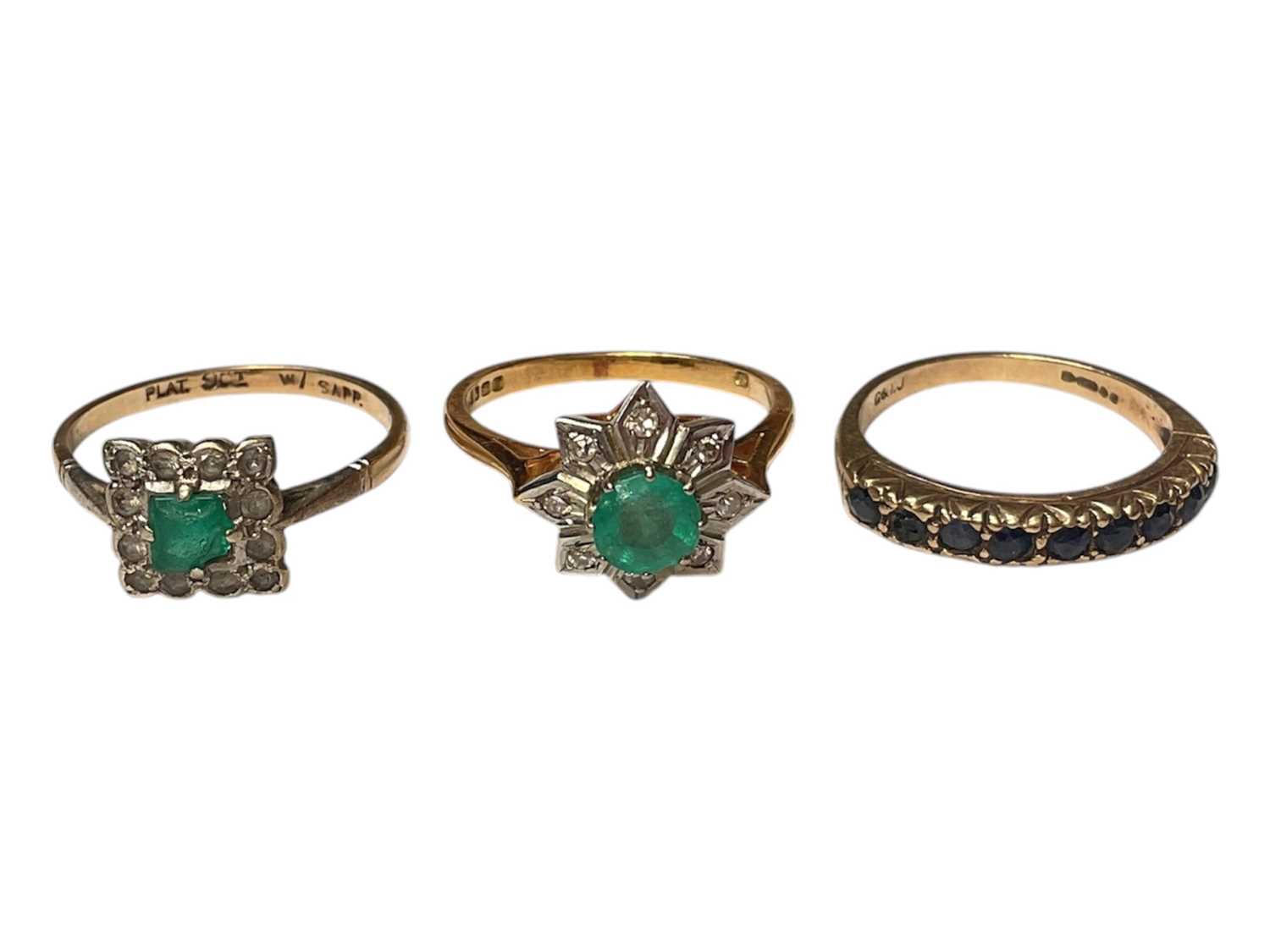Lot 28 - Emerald and diamond cluster ring in 18ct gold setting, 9ct gold sapphire half eternity ring and a 9ct gold synthetic stone dress ring (3)
