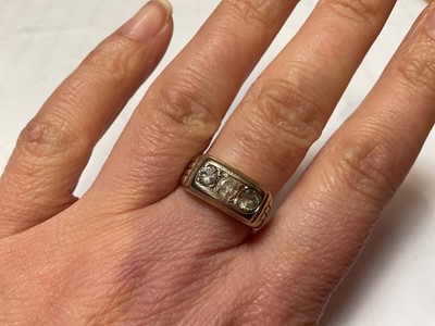 Lot 56 - Three stone ring with two diamonds and one synthetic replacement stone, in yellow metal setting, stamped 750.