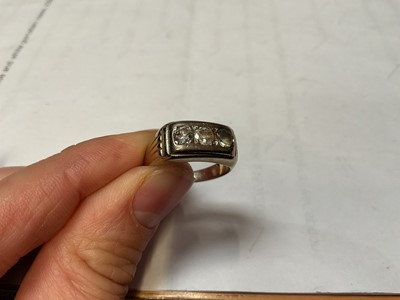 Lot 56 - Three stone ring with two diamonds and one synthetic replacement stone, in yellow metal setting, stamped 750.