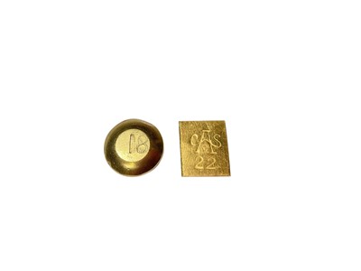 Lot 63 - Two yellow metal nuggets, the round disc stamped 18 and rectangular plaque stamped 22