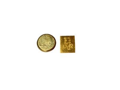 Lot 63 - Two yellow metal nuggets, the round disc stamped 18 and rectangular plaque stamped 22