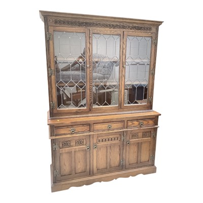 Lot 5325 - Old Charm oak two height bookcase/dresser with shelves above enclosed by two leaded glazed doors, three drawers and three panelled doors below, 136cm wide, 46cm deep, 190cm high