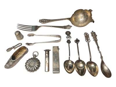 Lot 25 - Group of silver items to include an Edwardian novelty shoe, Victorian sovereign holder, tea strainer, fork, pair of sugar tongs, thimble etc, three Chinese silver teaspoons