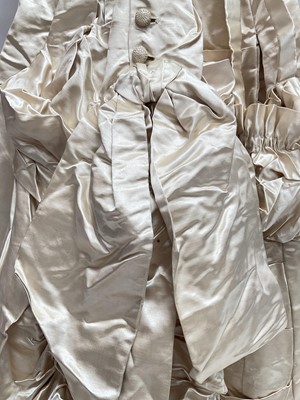 Lot 2500 - Exquisite 1882 wedding dress, cream satin silk with multi pleated trims, lace and tiny faux pearls to cuffs, hem and train. Front has boned bodice , ruched cream silk brocade panel with bow det...