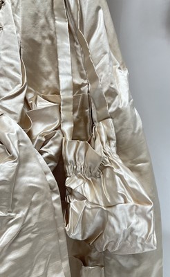 Lot 2500 - Exquisite 1882 wedding dress, cream satin silk with multi pleated trims, lace and tiny faux pearls to cuffs, hem and train. Front has boned bodice , ruched cream silk brocade panel with bow det...