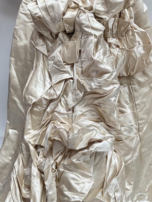 Lot 2500 - Exquisite 1882 wedding dress, cream satin silk with multi pleated trims, lace and tiny faux pearls to cuffs, hem and train. Front has boned bodice , ruched cream silk brocade panel with bow det...