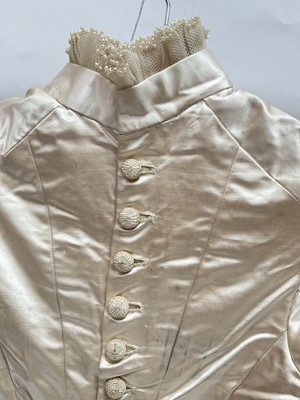Lot 2500 - Exquisite 1882 wedding dress, cream satin silk with multi pleated trims, lace and tiny faux pearls to cuffs, hem and train. Front has boned bodice , ruched cream silk brocade panel with bow det...