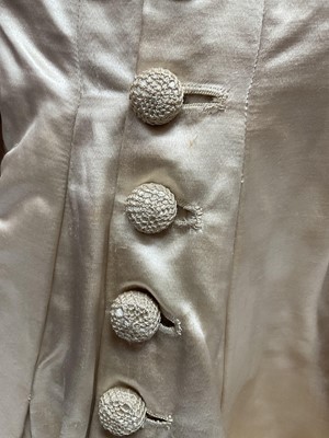 Lot 2500 - Exquisite 1882 wedding dress, cream satin silk with multi pleated trims, lace and tiny faux pearls to cuffs, hem and train. Front has boned bodice , ruched cream silk brocade panel with bow det...