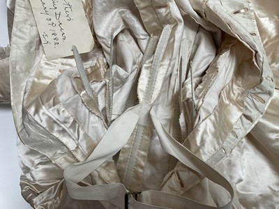 Lot 2500 - Exquisite 1882 wedding dress, cream satin silk with multi pleated trims, lace and tiny faux pearls to cuffs, hem and train. Front has boned bodice , ruched cream silk brocade panel with bow det...