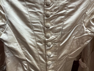 Lot 2500 - Exquisite 1882 wedding dress, cream satin silk with multi pleated trims, lace and tiny faux pearls to cuffs, hem and train. Front has boned bodice , ruched cream silk brocade panel with bow det...
