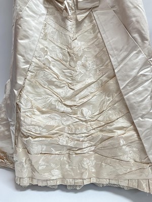 Lot 2500 - Exquisite 1882 wedding dress, cream satin silk with multi pleated trims, lace and tiny faux pearls to cuffs, hem and train. Front has boned bodice , ruched cream silk brocade panel with bow det...