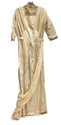 Lot 1911 wedding dress, cream silk brocade with lace and silk crepe drapes, boning to sides of bodice. Short square edge train. Provenance - hand wriiten note attached '8th February 1911 My wedding...