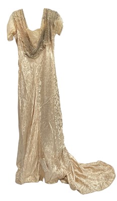 Lot 1911 Evening gown by Reville & Rossiter, Hanover Square, London. Cream satin silk in scrolling shamrock design with various laces, paste stones and faux pearls, boned bodice with label, dres...