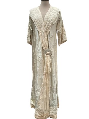 Lot 2512 - Circa 1920s Eau De Nil silk housecoat with cross-over front, circular designed fastening and cream silk crepe pleated edging.