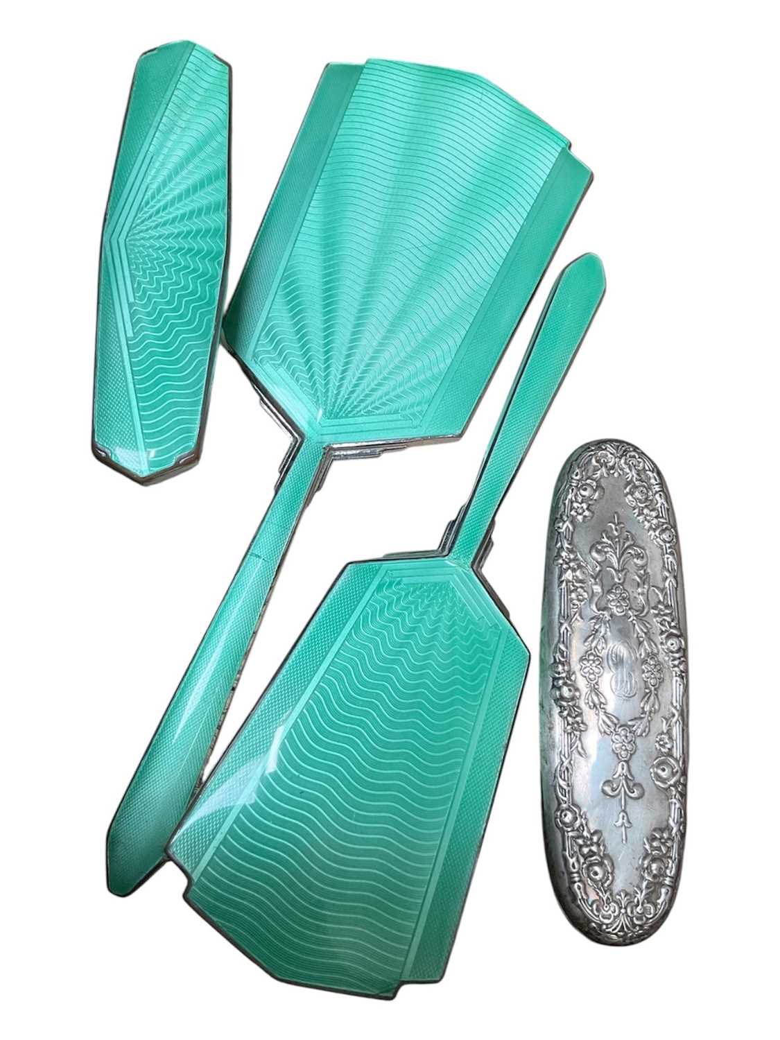 Lot 44 - Sterling silver mounted brush (stamped sterling 70) and a three piece silver plated and green guilloche enamel dressing table set