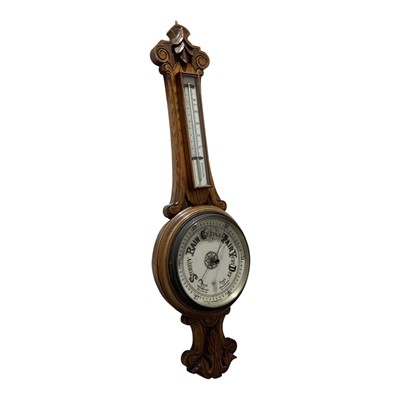 Lot 5137 - Edwardian oak carved banjo barometer and thermometer
