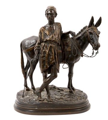 Lot 839 - Alfred Dubucand (1828-1894) - Bronze figure of an Arab and his donkey, signed, on integral naturalistic oval stepped plinth, 35cm high