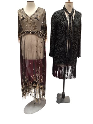 Lot 2516 - 1920s flapper over-dress of black net with black and gold beading, black silk embroidery and beaded tassels. Plus a black velvet devore loose jacket with low placed large burron and attached ta...