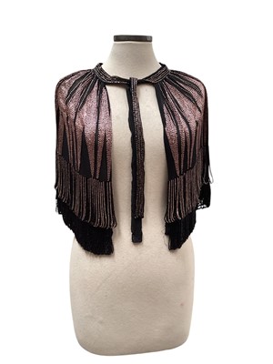 Lot 2518 - 1920s / 30s Art Deco black crepe silk capelet with rose pink 'sunburst' beaded and beaded tassels, matching detachable sleeves. Plus a 1920's pink and silver metallic lace cocktail dress and t...